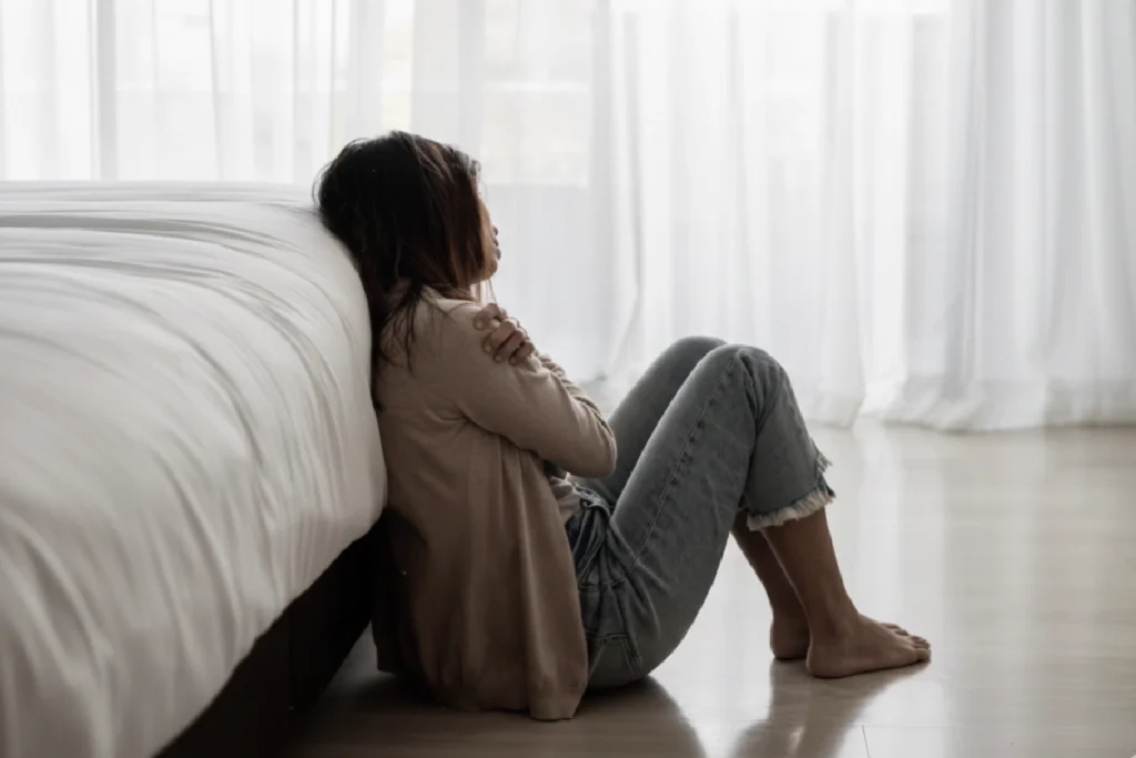 mulher deprimida sentada no chão